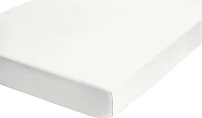 A close-up view of a white fitted sheet, showing the texture of the fabric and the elasticized corner.