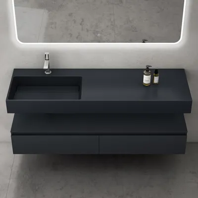 A modern floating bathroom vanity with a sink and faucet, mounted on a gray tiled wall with a lighted mirror above.
