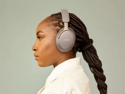 A woman wearing headphones, shown from the side.