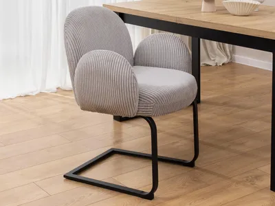 Produktbild von Vela - Polsterstuhl im Japandi Stil und im runden Design aus grauem Cord mit schwarzem Metallgestell