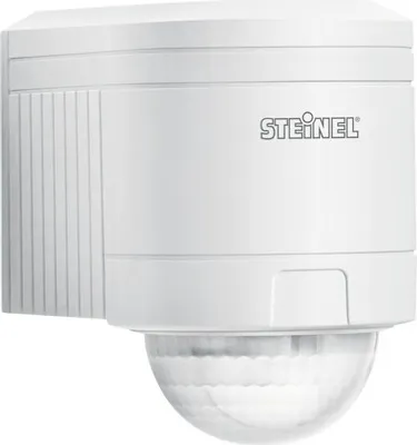 A white infrared motion detector mounted on a wall.