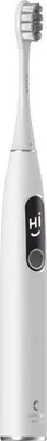 A white electric toothbrush with a black panel displaying a smiley face and the letters "HI".