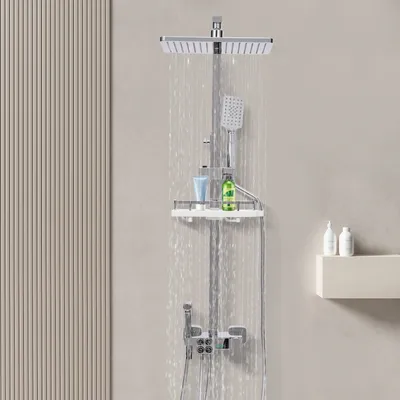 A modern shower system with a rainfall showerhead, handheld showerhead, and a shelf for toiletries, set against a neutral background with a textured wall panel on the left.