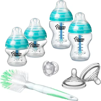 A collection of baby bottles and accessories arranged on a white background.