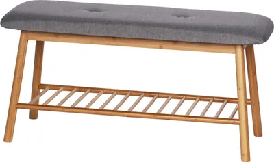 A bench with a grey upholstered seat and a slatted wooden shelf underneath.