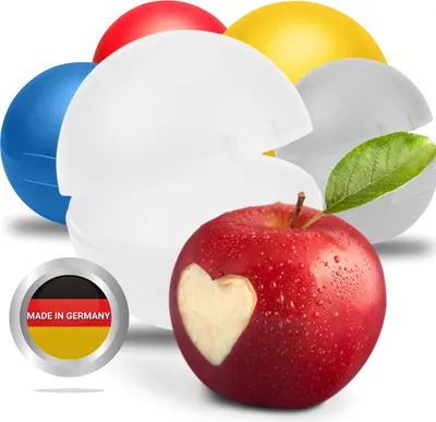 A collection of colorful round containers, one of which is open, with a red apple carved with a heart in the foreground.