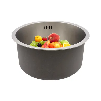 A round stainless steel sink filled with various fruits, presented on a white background.