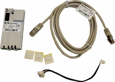 A collection of electronic components, including a device, a cable, and small adhesive pads, laid out on a white background.