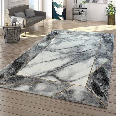 A modern living room with a sofa, side table, and a marble-patterned rug.