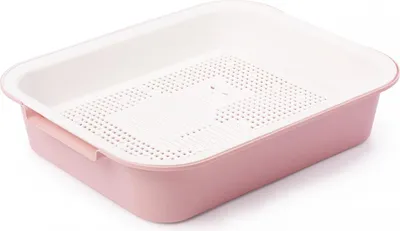 A pink and white litter box with a sieve.