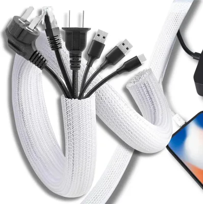 A bundle of various cables, including power plugs and USB connectors, are organized within a white mesh cable sleeve.