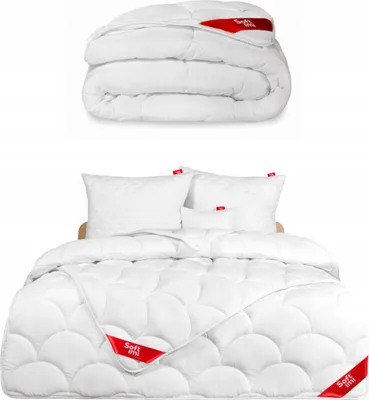 A folded duvet and a bed with pillows and a duvet.