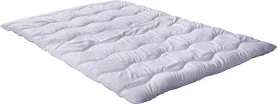 A white quilted comforter laid out flat on a white background.