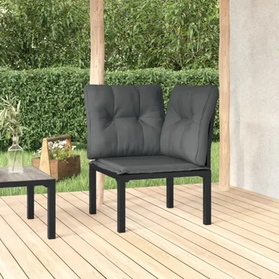 An outdoor patio setting with a corner chair and a small table.