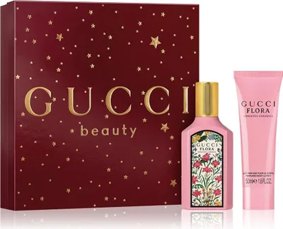 A Gucci Flora Gorgeous Gardenia gift set with a perfume bottle and lotion tube, presented in a decorative box.