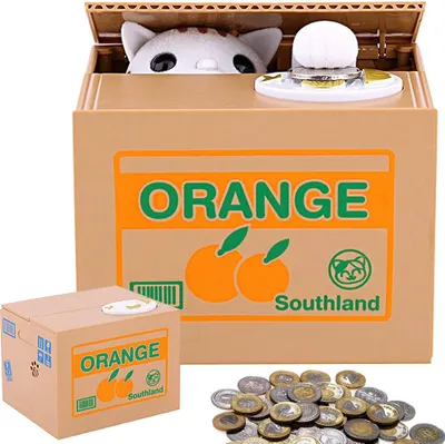A product shot of a coin bank shaped like a box with a cat peeking out, along with a smaller version of the product and a pile of coins.