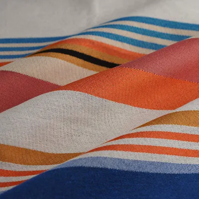 Produktbild von Jacquard Stoff mit bunten Streifen in Blau, Orange, Rosa auf Ecru, 280 cm breit