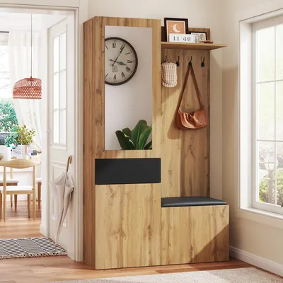 A hallway or entryway with a wooden furniture set including a mirror, hooks, and storage.
