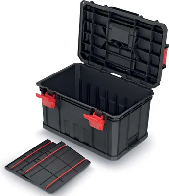A black toolbox with red latches is shown with its lid open. A separate black tray with red accents is placed in front of the toolbox.