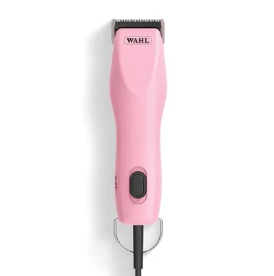 A pink Wahl KM2+ dog clipper is shown against a white background.