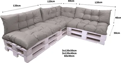 A sectional outdoor sofa made from white wooden pallets with gray cushions.