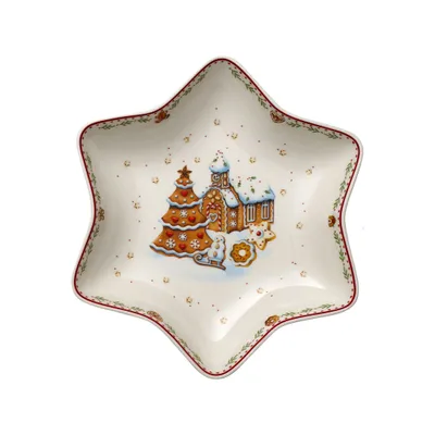 A star-shaped dish with a Christmas-themed gingerbread village design.