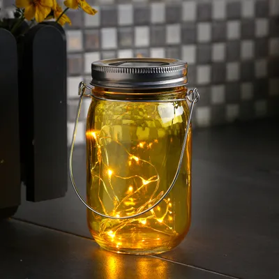 Produktbild von LED Solar Glas - Windlicht - mit Drahtlichterkette - Lichtsensor - H: 14cm - D: 8cm - gelb