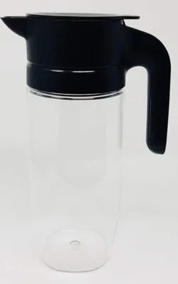 A clear studio shot of a transparent pitcher with a black lid and handle.