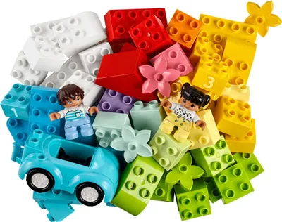 A pile of colorful building blocks with two small figures and a toy car.