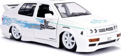 A white Jada Fast&Furious 1995 Volkswagen Jetta 1:24 scale model car is displayed on a white background.