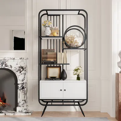 A modern black and white bookshelf with decorative items and a fireplace in the background.