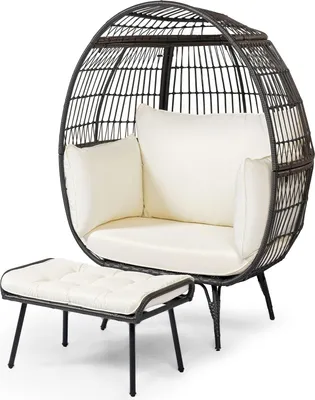 A dark gray rattan egg chair with white cushions and a matching ottoman, presented against a white background.