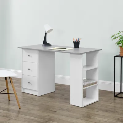 A modern white and light gray desk with drawers and shelves, set against a light blue wall and wooden floor.