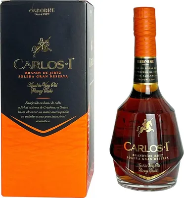 A bottle of Carlos I Imperial Brandy de Jerez and its packaging are displayed against a white background.