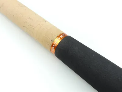 Close-up of a fishing rod handle with cork and black grip, featuring an orange band with the brand name.