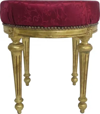 A round stool with a patterned bordeaux red fabric seat and gold-colored legs.