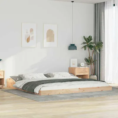 A bedroom scene with a bed frame and bedding.