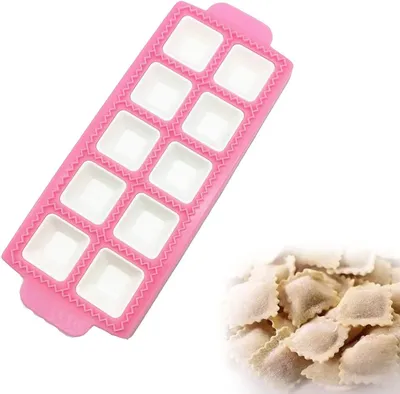 A pink ravioli maker mold and a pile of ravioli.