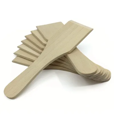 A stack of wooden spatulas arranged in a fanned pattern on a white background.