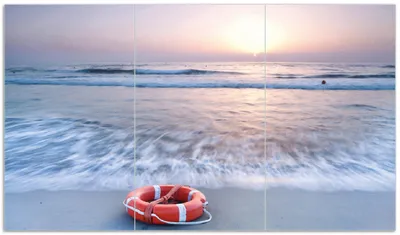 Produktbild von Wallario Herdabdeckplatte aus Glas, Größe 90 x 52 cm 3-teilig, Motiv Rettungsring am Strand bei Sonnenuntergang