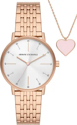A rose gold Armani Exchange watch and a pink heart necklace are displayed against a white background.