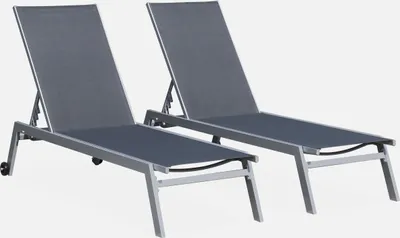 Two gray lounge chairs are shown against a white background.