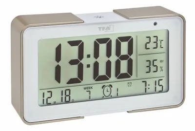 A digital alarm clock is shown against a white background.