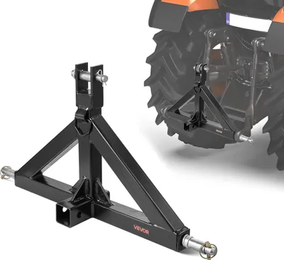 A black tractor hitch adapter is shown in the foreground, with a blurred tractor in the background.