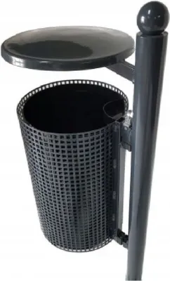 A dark gray outdoor trash can with a perforated basket and a lid, mounted on a pole.