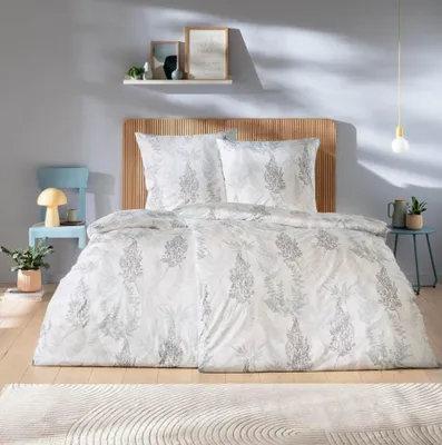 A bedroom scene with a bed, chair, and shelf.