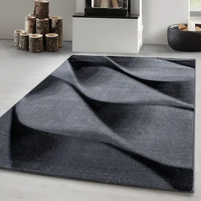 A modern abstract design rug in a living room setting.