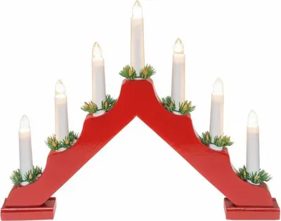 A red wooden advent candle holder with seven white LED candles and green decorative accents.