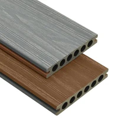 Two composite decking boards, one gray and one brown, are shown layered and angled on a white background.