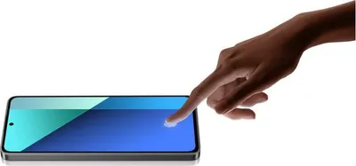 A hand is touching the screen of a smartphone.